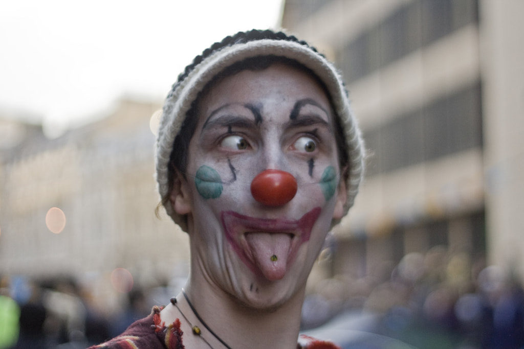 Man in clown make-up with tongue sticking out
