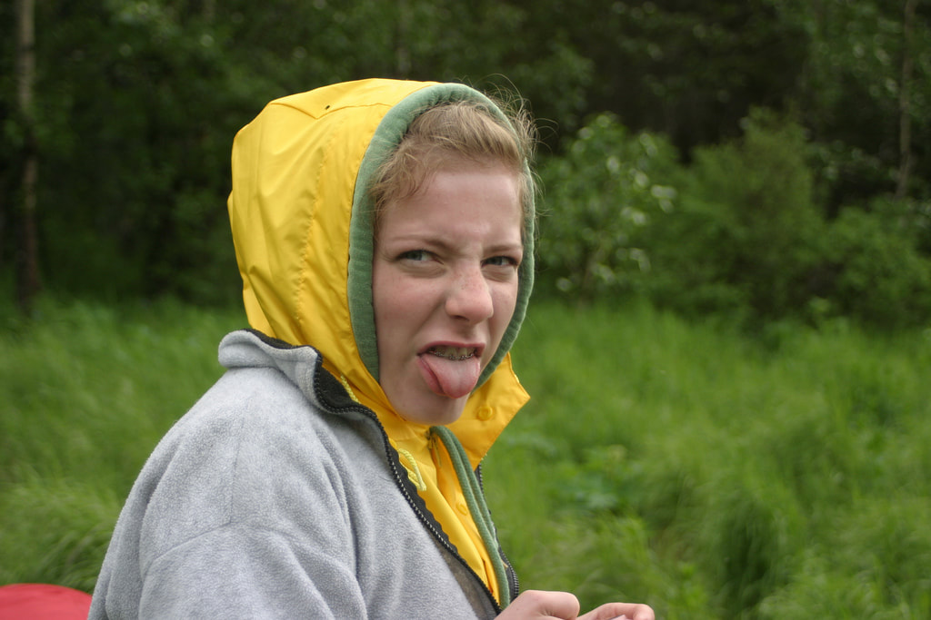 woman sticking out tongue at camera